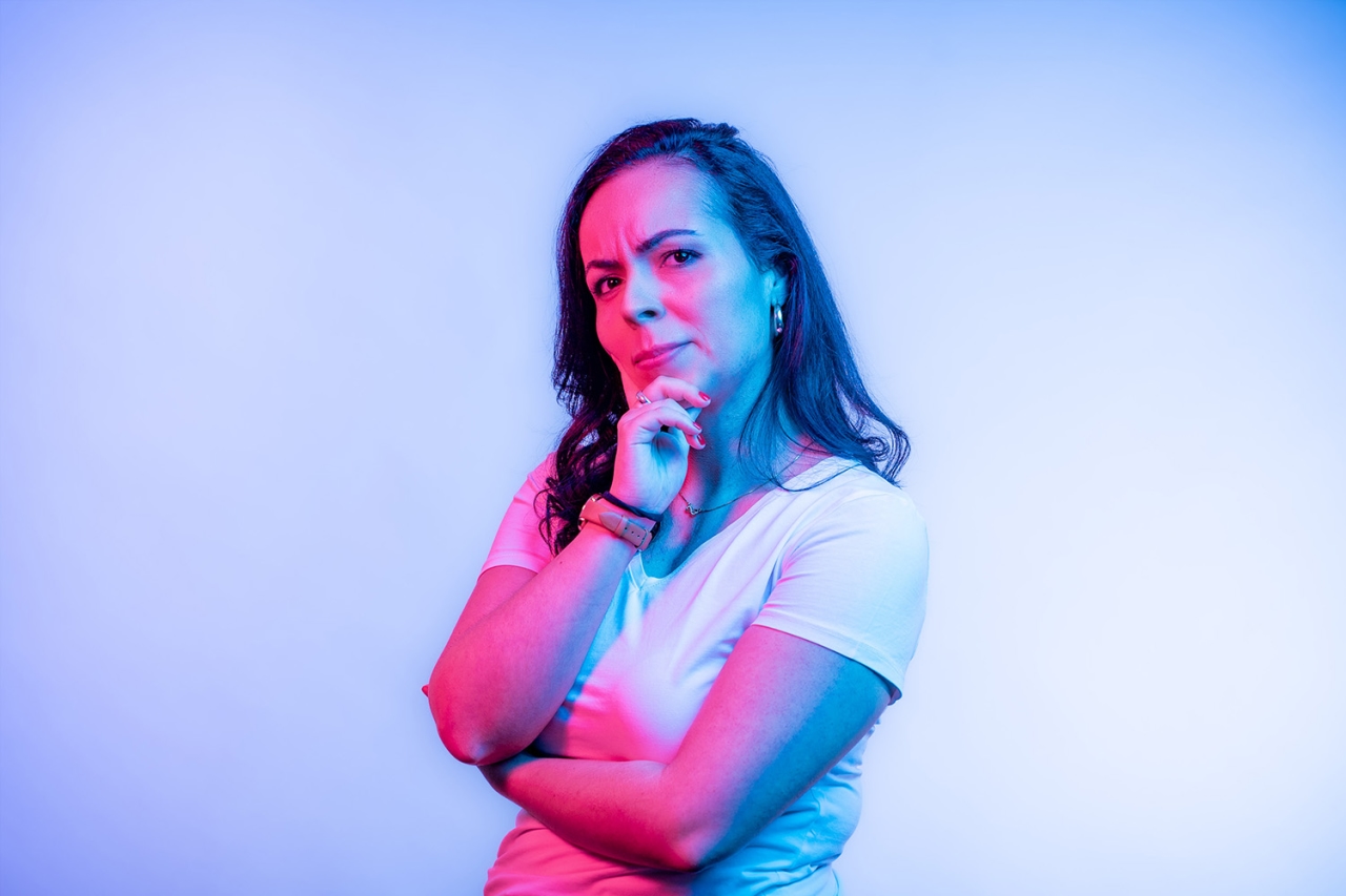 Woman holds her chin broodingly